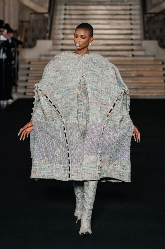 Model in oversized grey textured sculptural dress