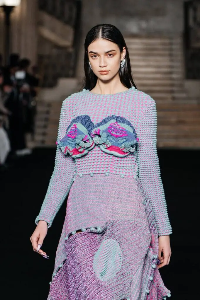 Model in pastel pink and blue textured knit outfit