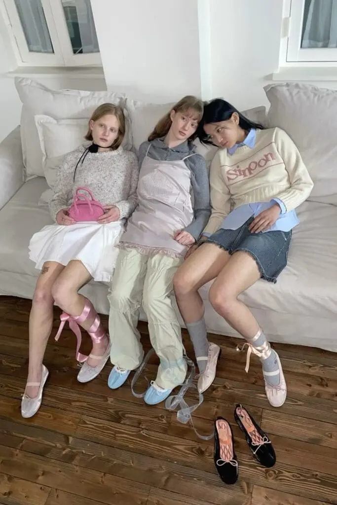 Three girls in Coquettecore outfits with ballet flats