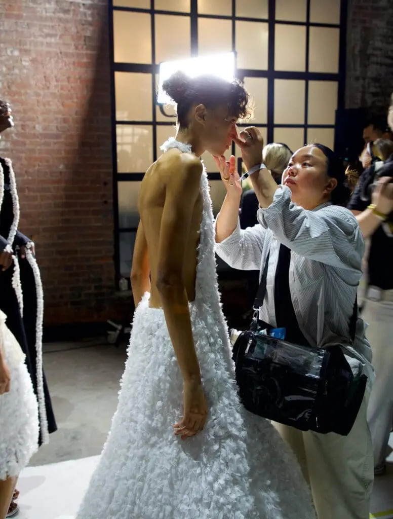 Diotima backstage fitting with white gown at NYFW