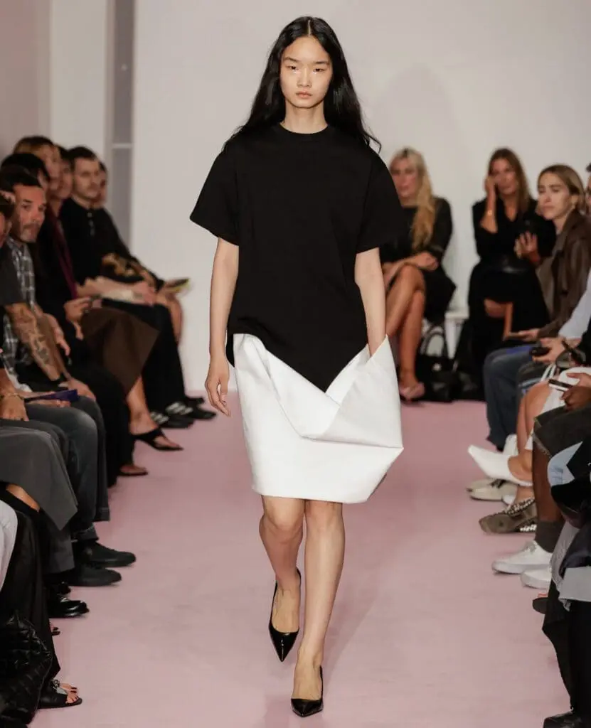 Lii model in black top and white skirt NYFW runway