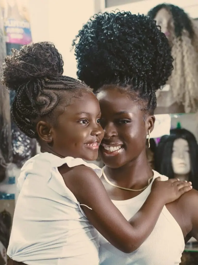 Black mother and daughter smiling together