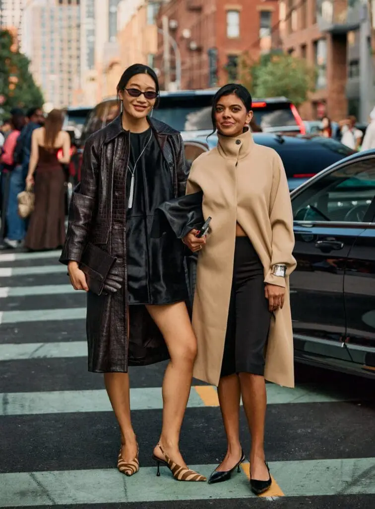 NYFW street style two women in leather coat and beige dress