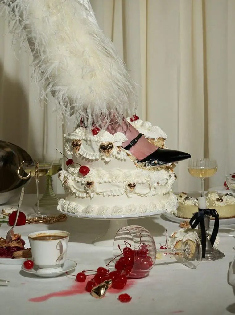 foot in high heel stepping into decorated cake