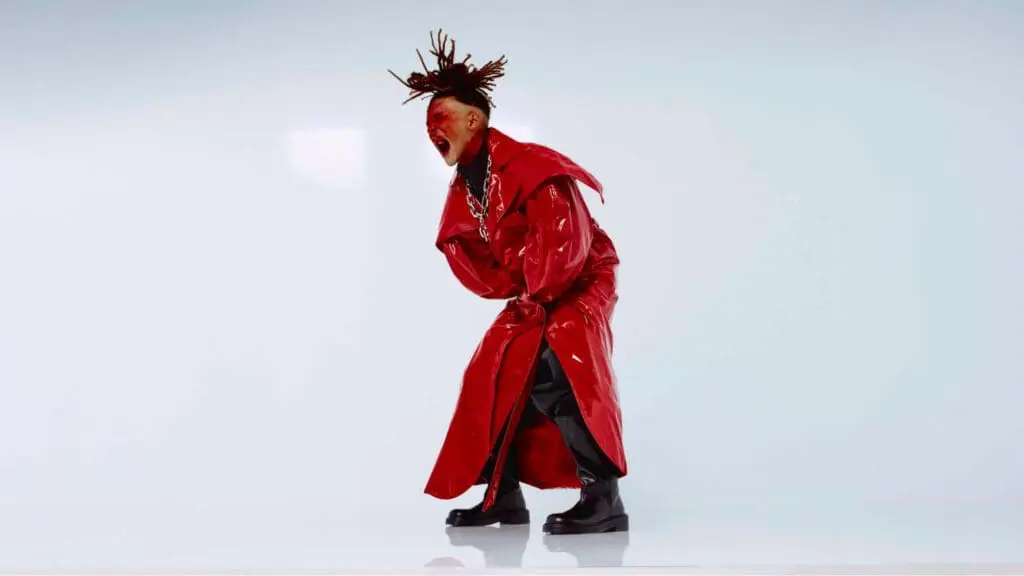 Jaden Smith wearing red coat in minimalist Louboutin campaign shoot