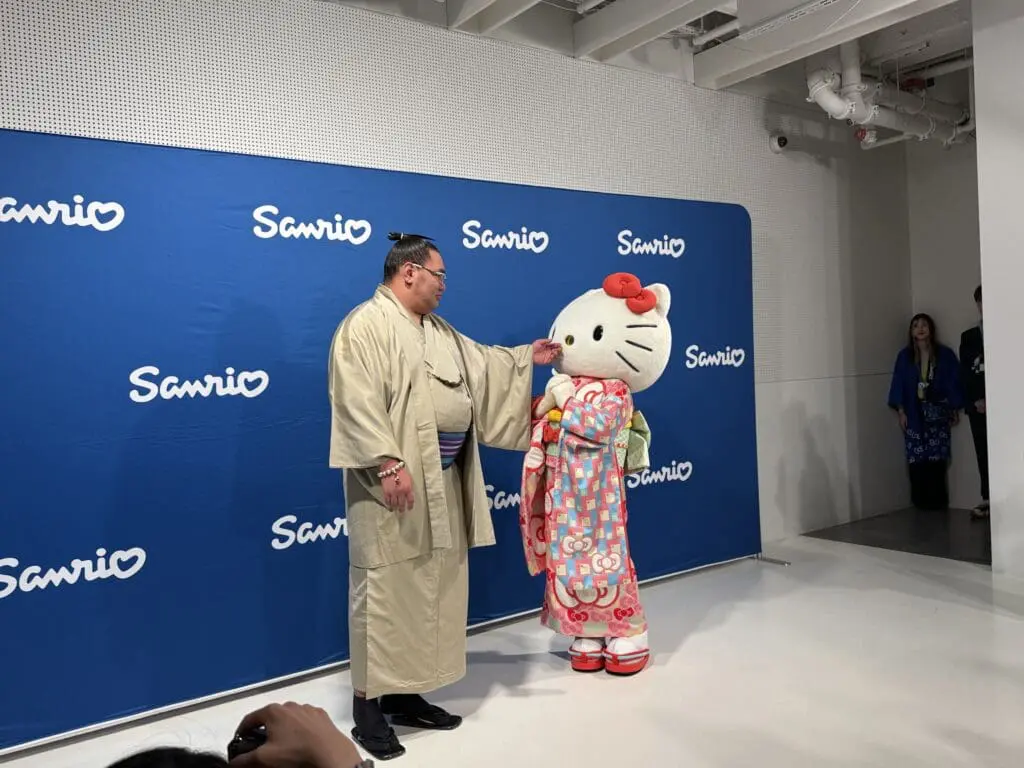 Sumo Yokozuna greets Hello Kitty in kimono during Tokyo announcement