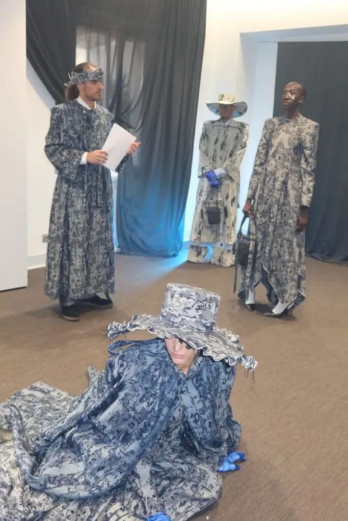 Model reading Dante-inspired text in Victor Hart Defiant show Milan