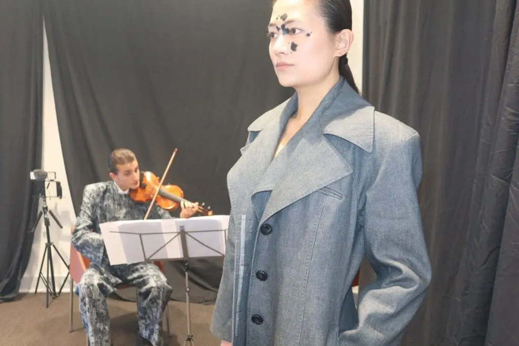 Victor Hart Defiant fashion show violinist performing beside model