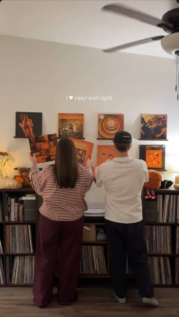 Couple arranging vinyl wall display at home