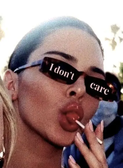 woman with sunglasses saying “I don’t care” holding lollipop