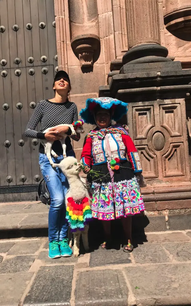 With a local woman and a llama, cultural respect