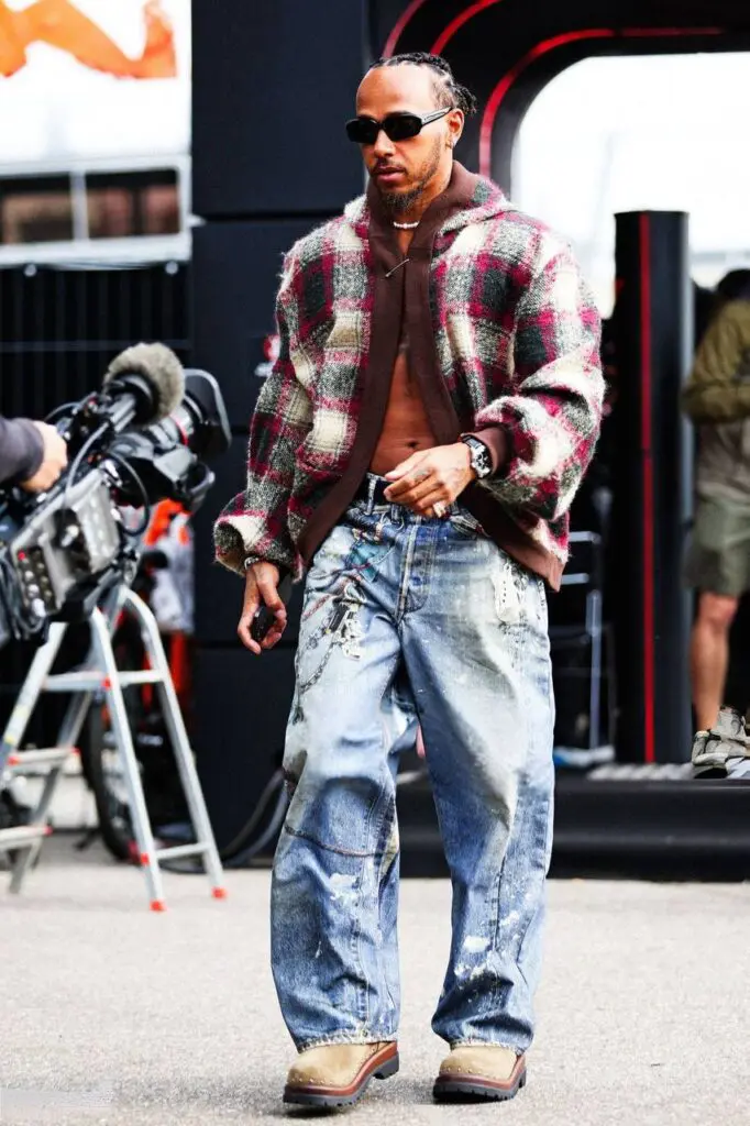 F1 driver in streetwear flannel and jeans off the track