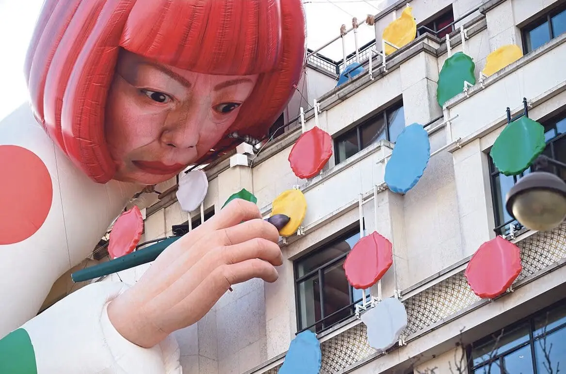 giant painter inflatable art on building facade
