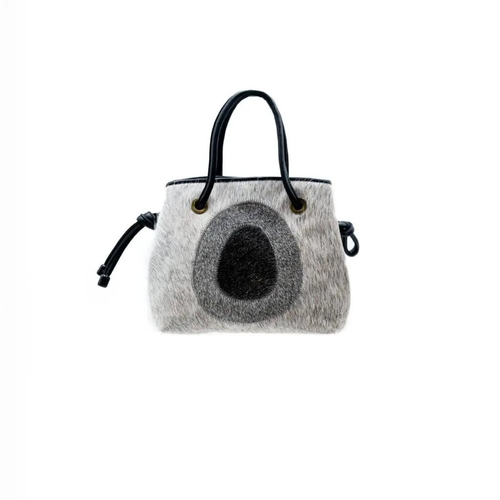 grey pony hair tote with black oval motif and handles
