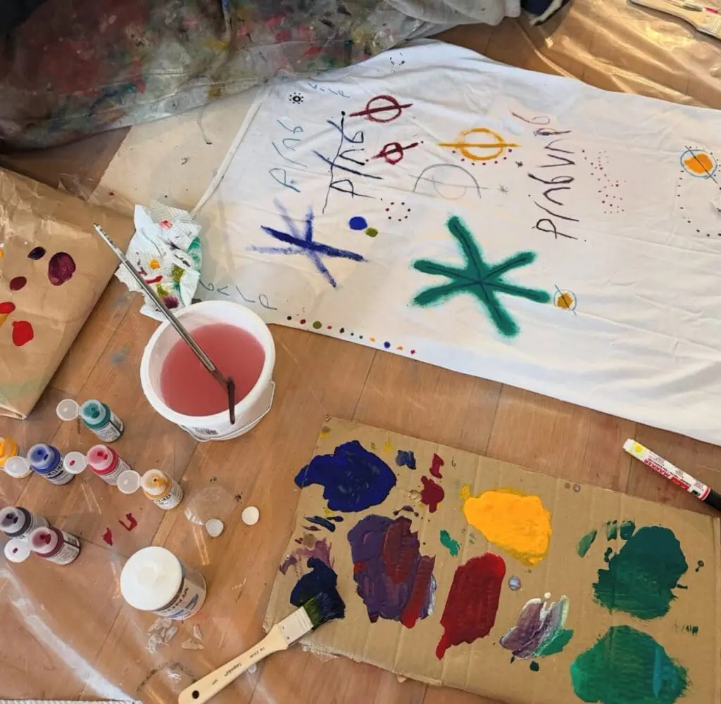 Paint tests and color swatches on fabric worktable