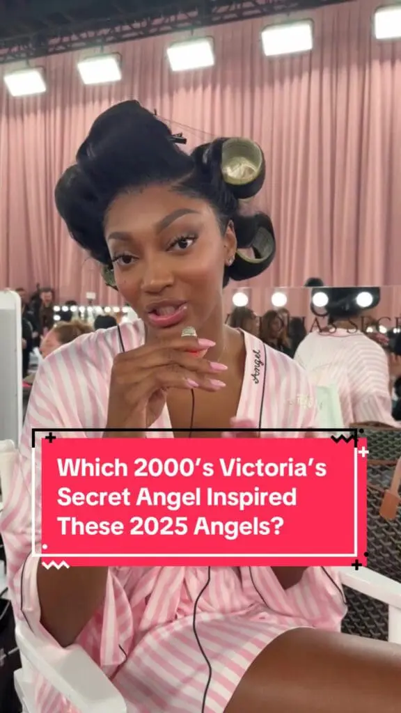 backstage model in pink robe speaking to camera