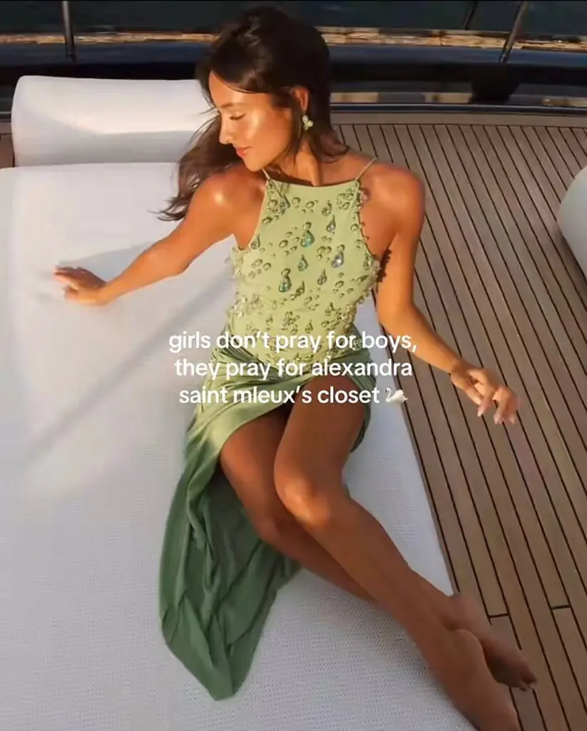 Fashion influencer in a green slip dress on a yacht