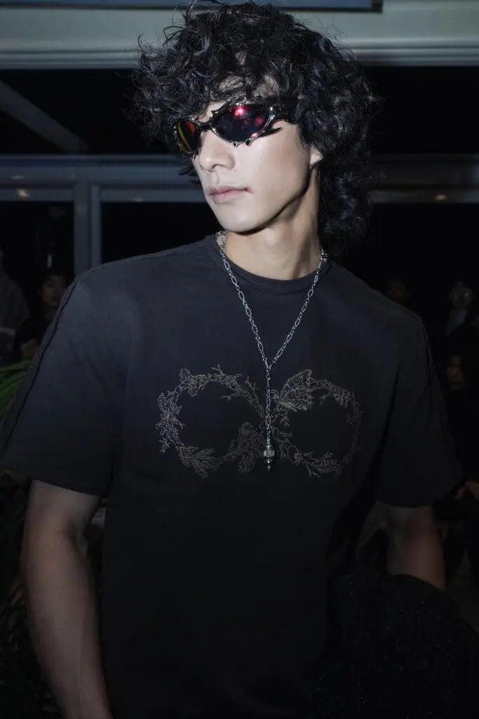 Close-up of graphic tee and sunglasses detail