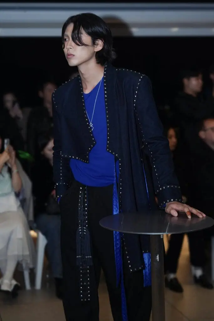 Blue knit layer with black set on the runway
