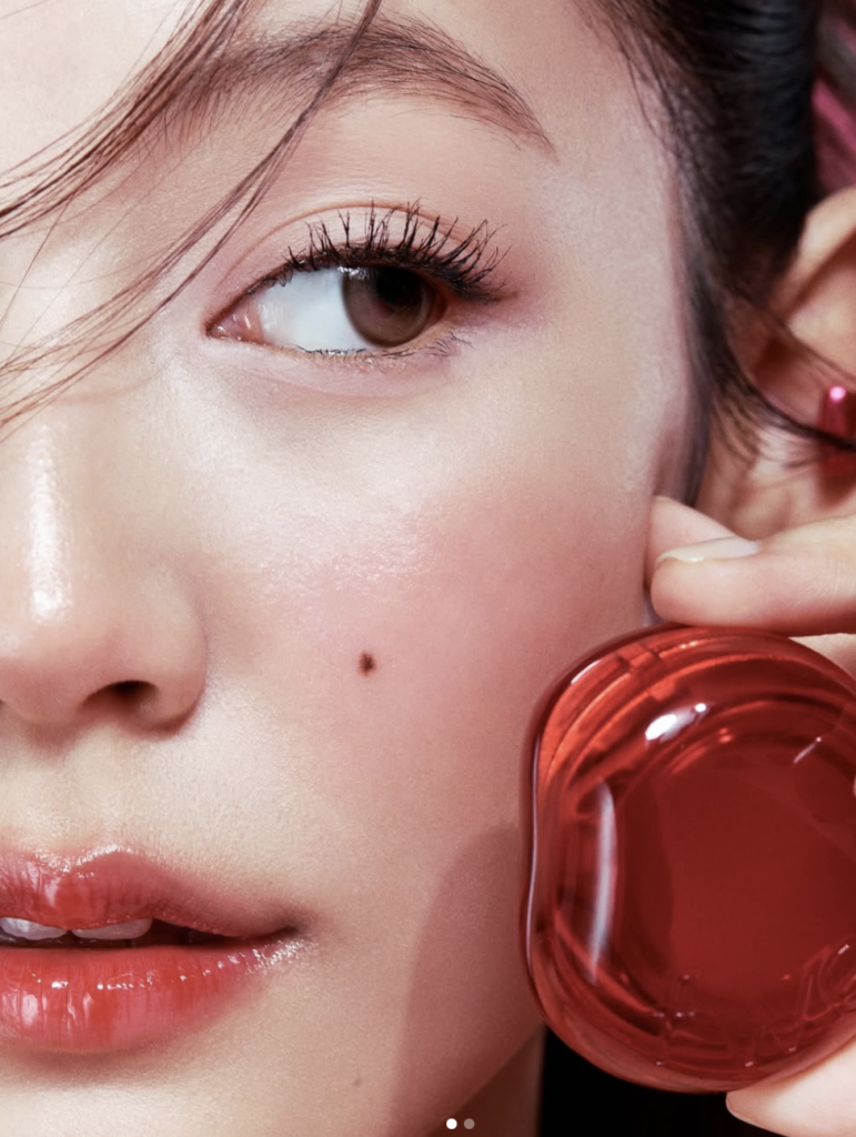 close-up of diffused blush on cheek with glossy lips