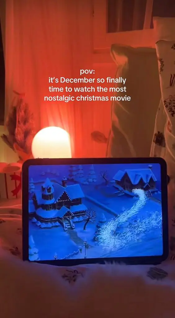 cozy Christmas movie on tablet warm red lighting