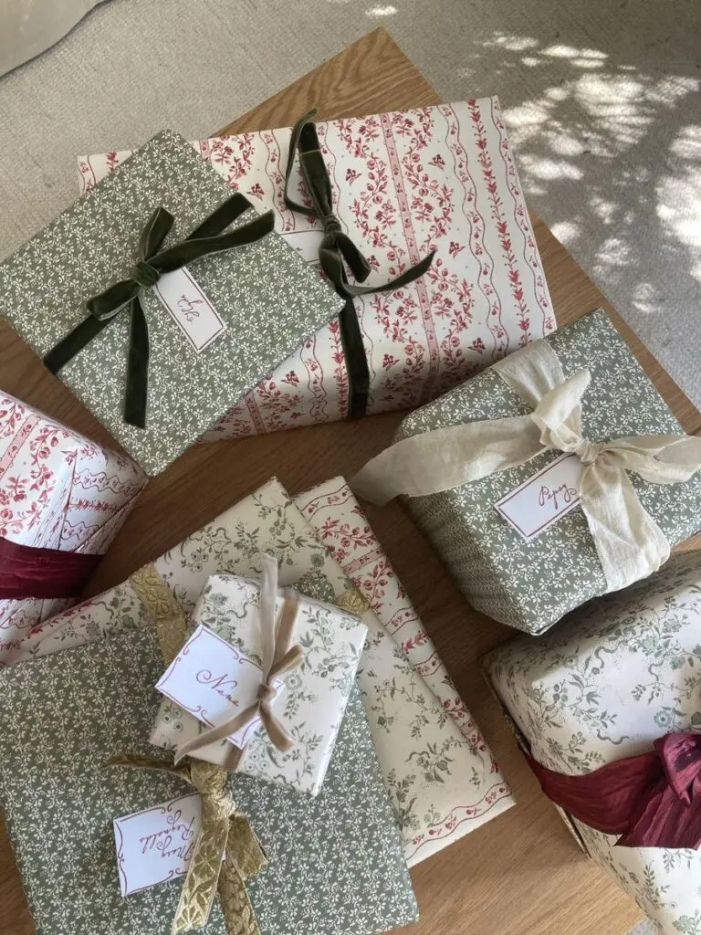 wrapped gifts with floral paper and velvet ribbon bows