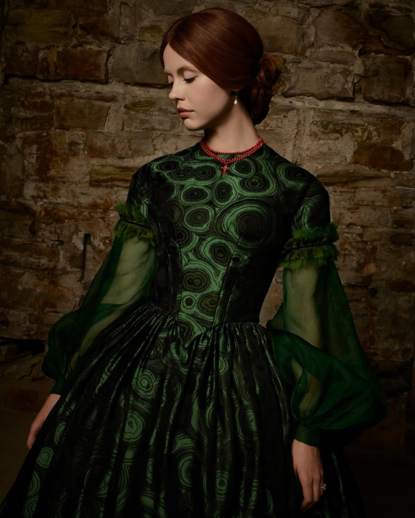 Elizabeth in a malachite green gown with coral bead necklace in del Toro’s Frankenstein