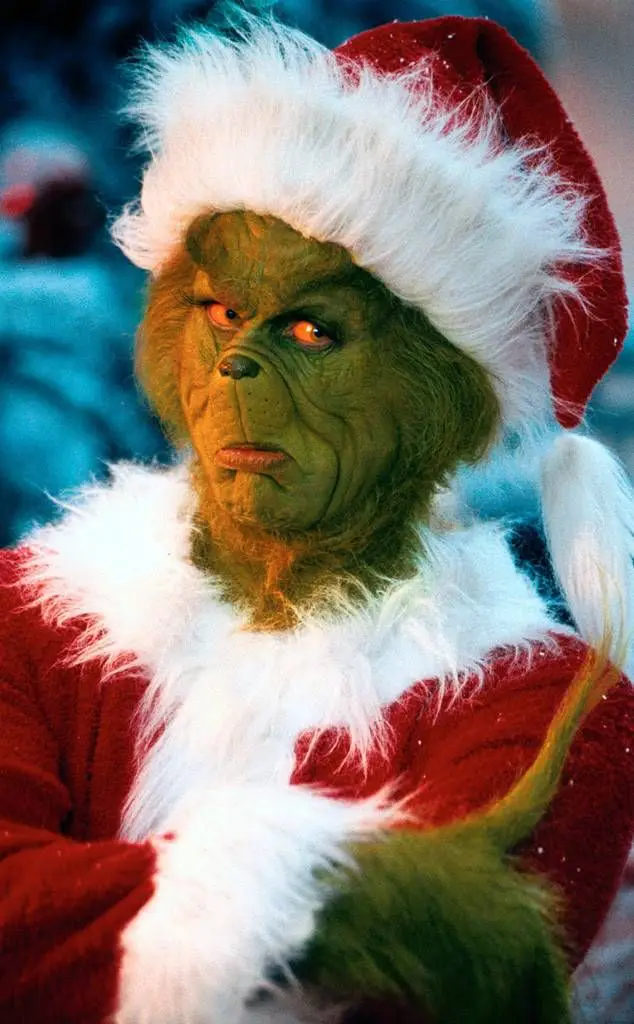 green holiday character in Santa hat Christmas movie