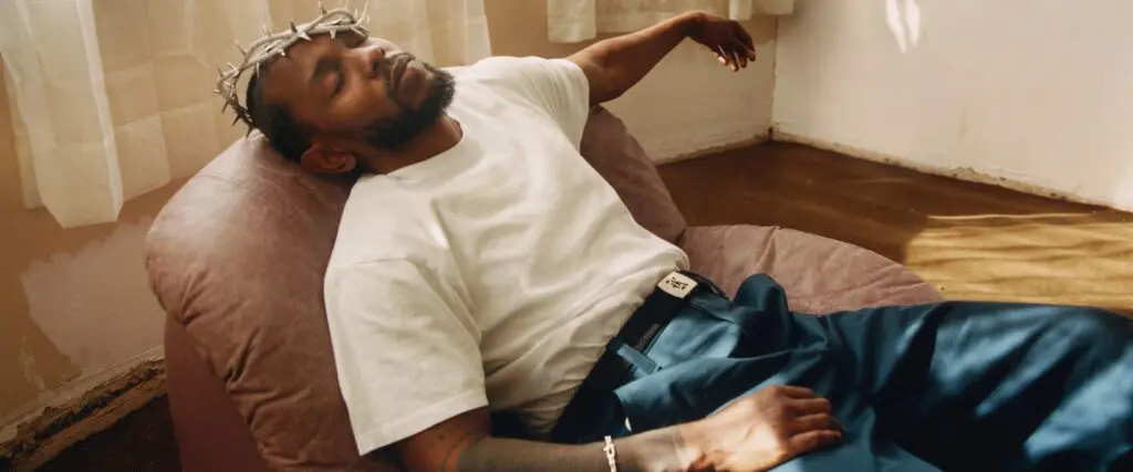 man reclining in chair with crown-like headband indoors