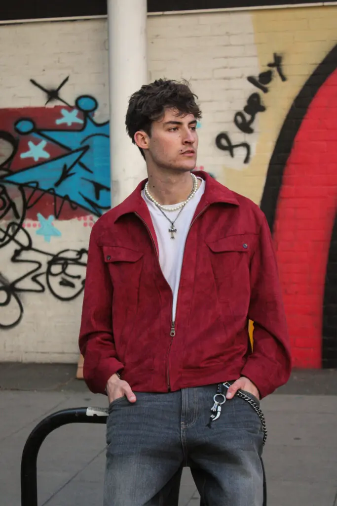 Red suede jacket street style with pearl necklace and cross pendant