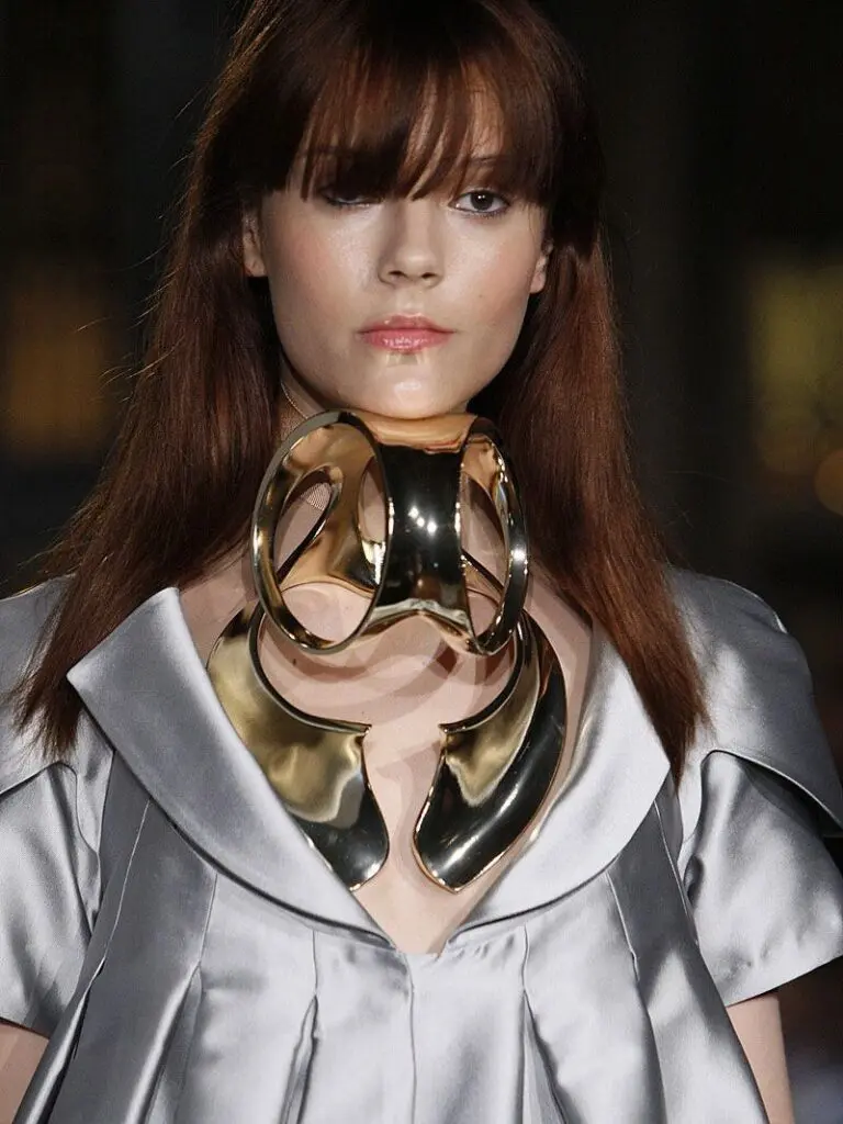 Avant-garde runway look with oversized sculptural gold collar necklace