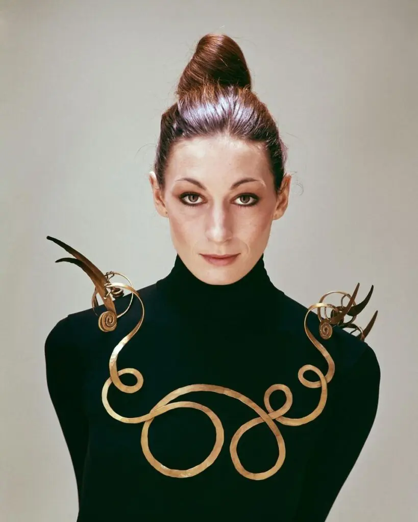 Surreal jewelry portrait with gold wire collar on black turtleneck