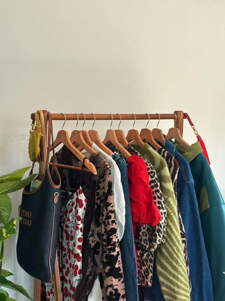 Vintage mix on wooden rail with Miu Miu tote, secondhand fashion