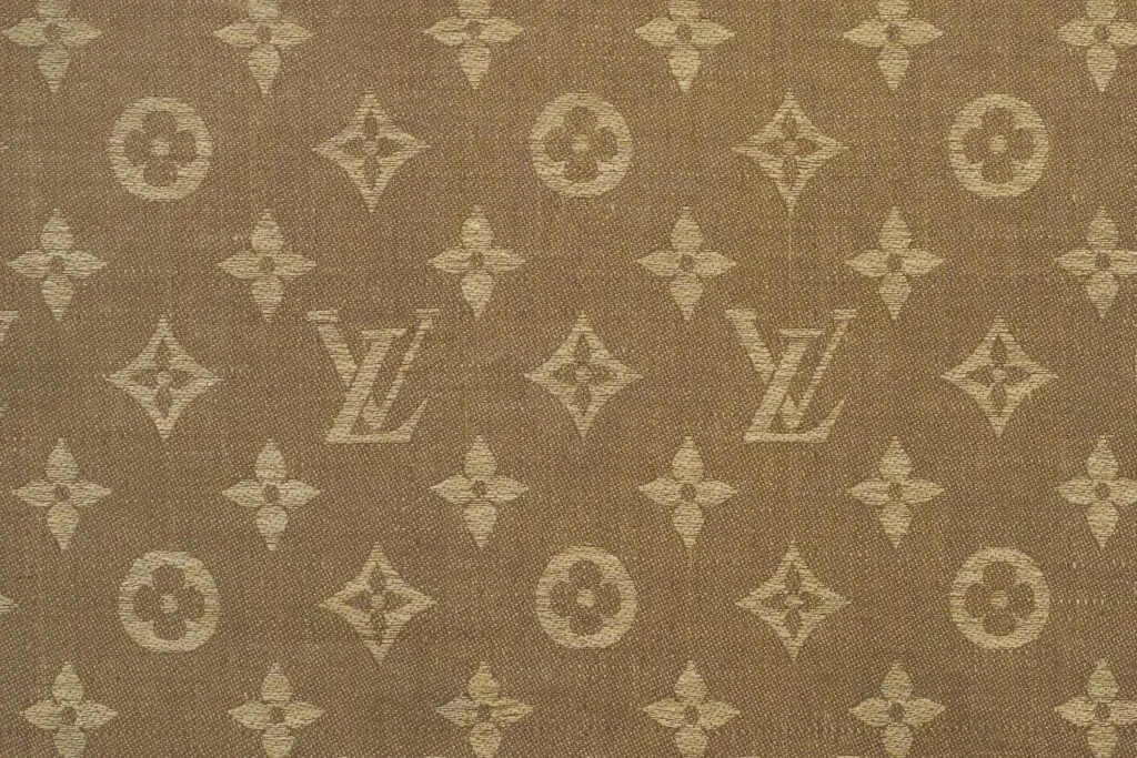 Louis Vuitton monogram canvas pattern close-up, beige