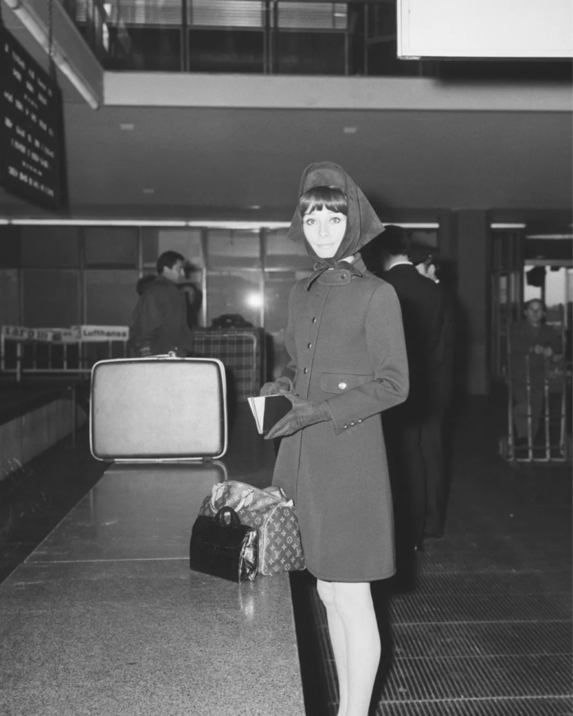 Vintage travel photo of woman with suitcase, Louis Vuitton mood