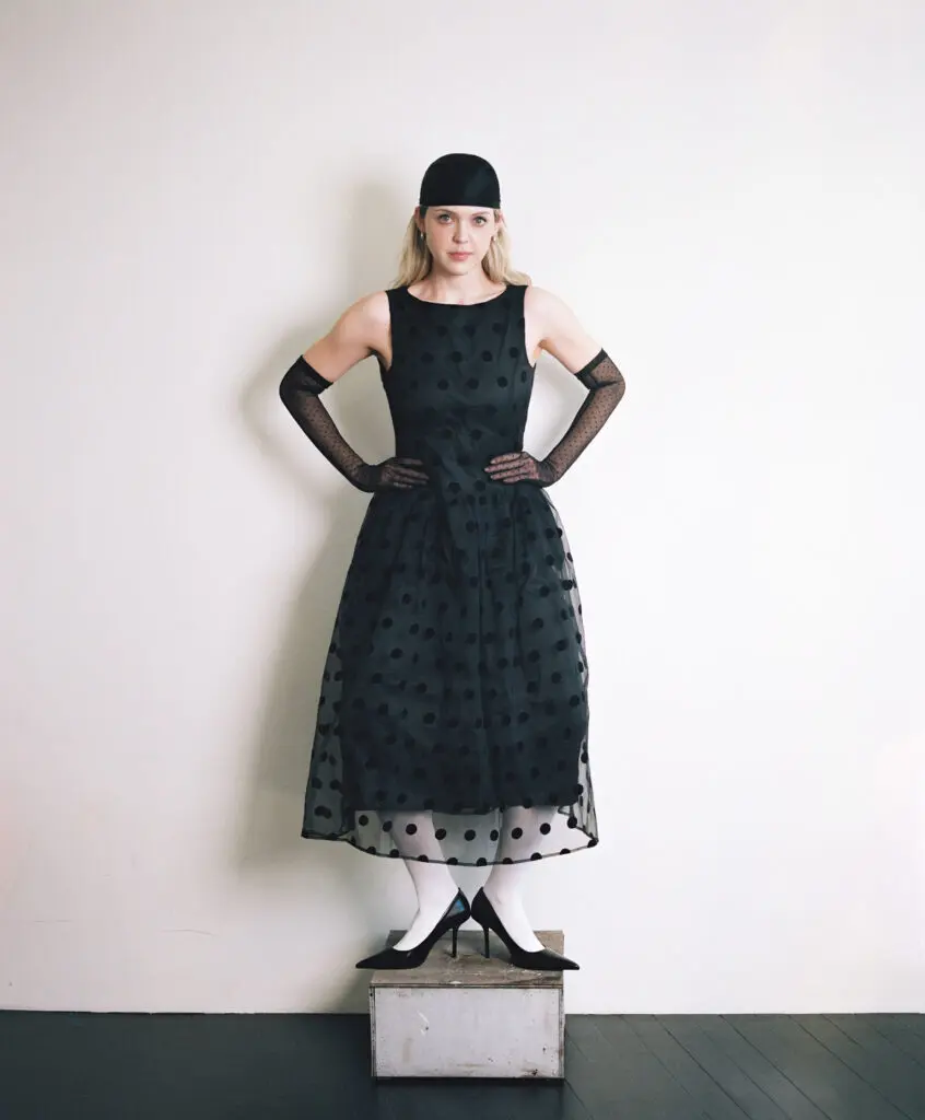 A raw Polaroid portrait of Carson Allen in a white dress, revealing softness, intimacy, and an unfiltered editorial sensibility.