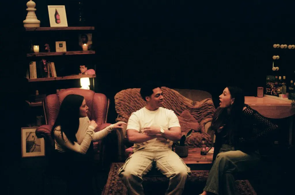 Actors in an intimate unscripted scene discussion on stage