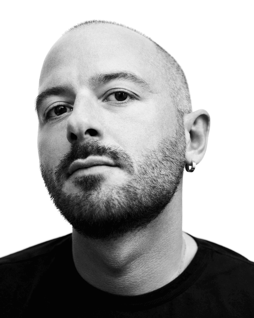 Close-up black and white portrait of Demna Gvasalia with a neutral expression