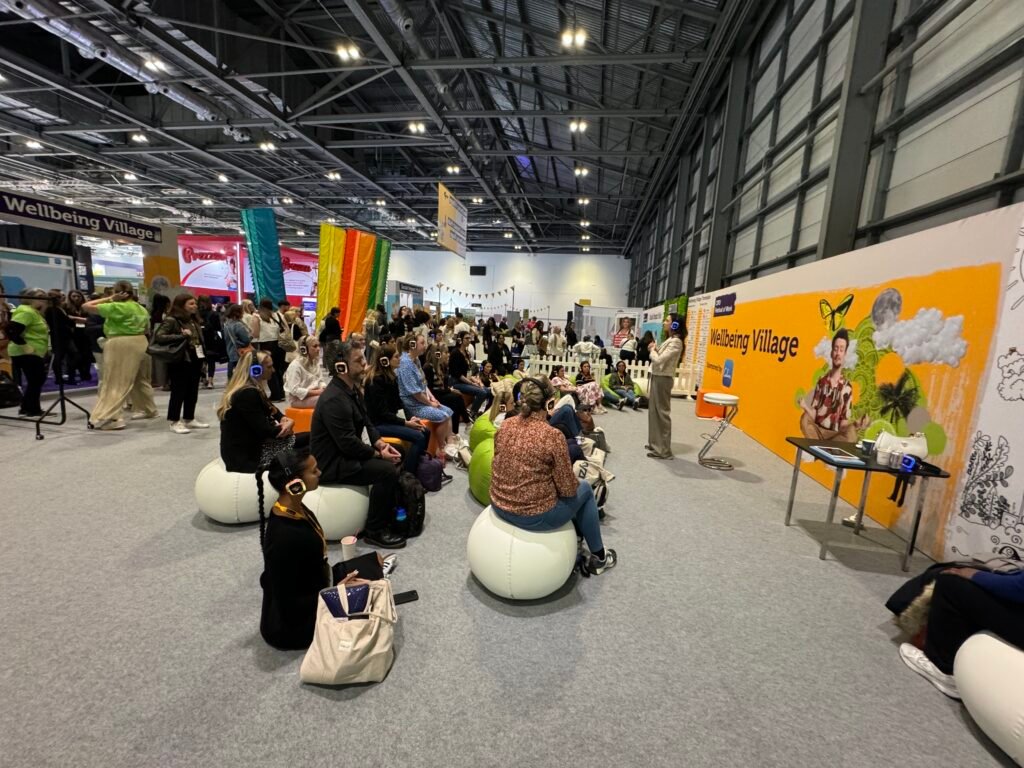 Audience at indoor expo for a wellbeing discussion