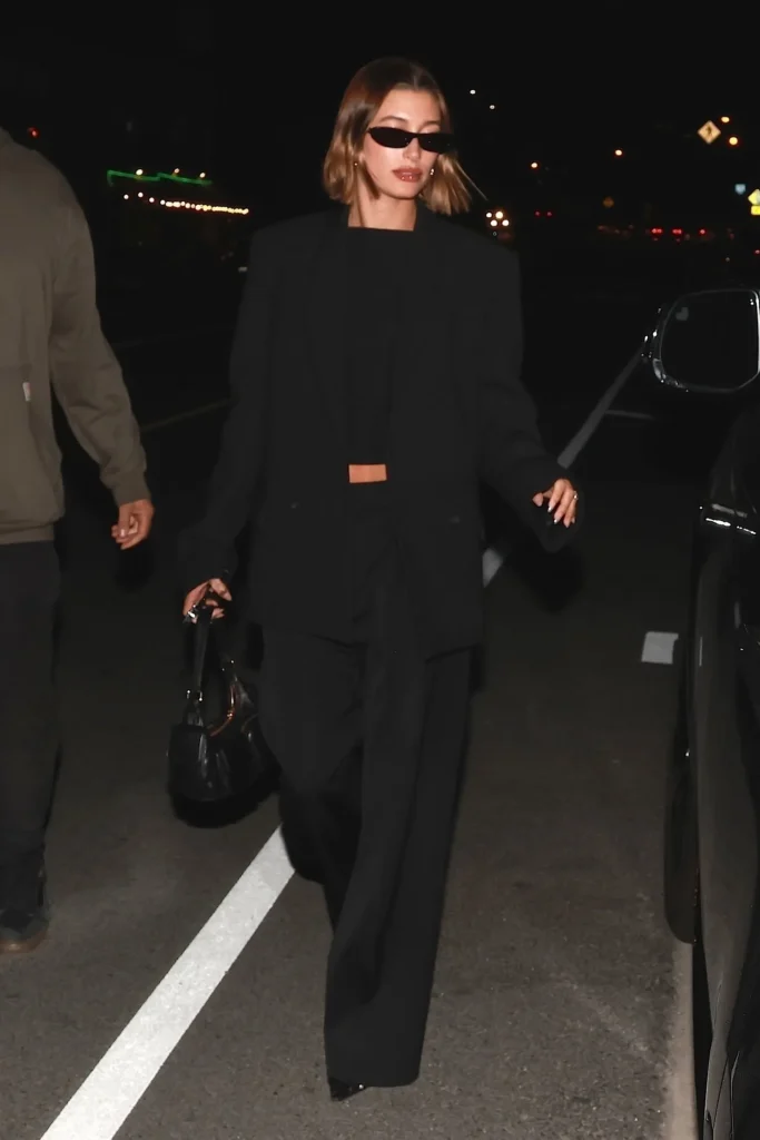 Hailey Bieber in oversized black suit and sunglasses