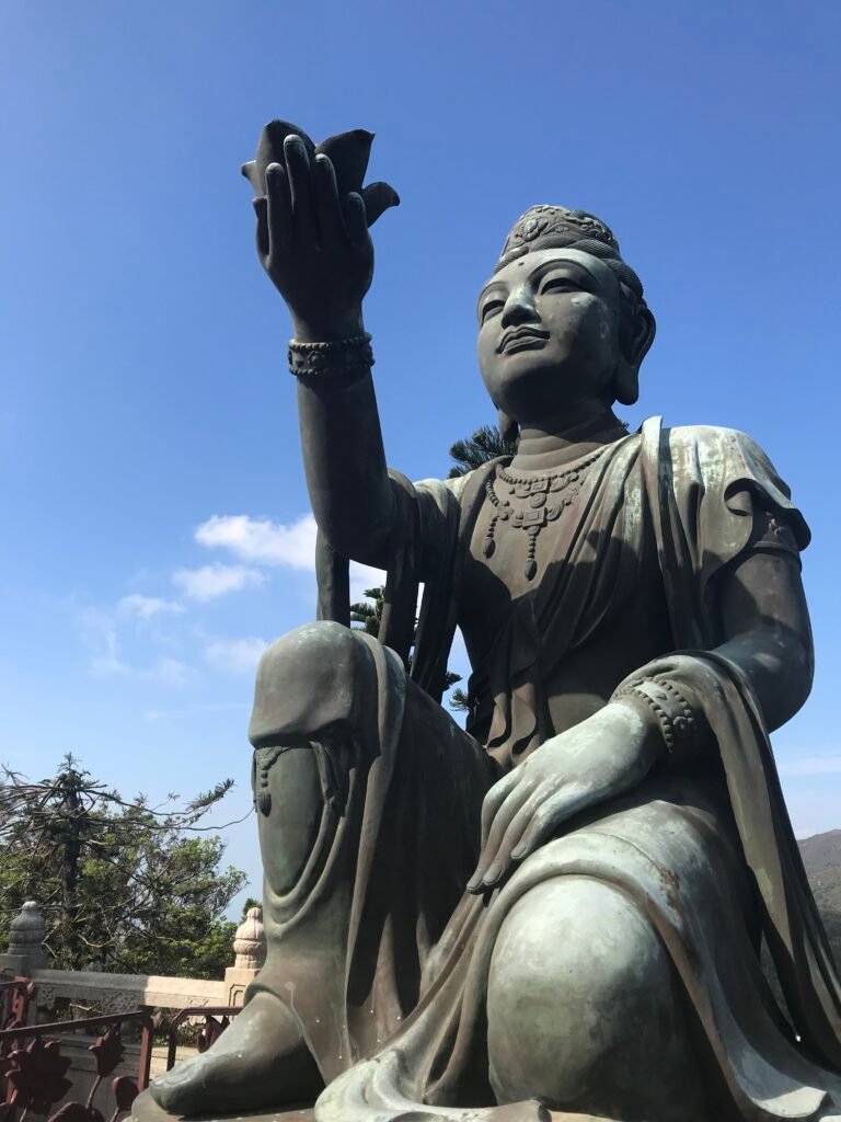 Large bronze statue under a clear blue sky