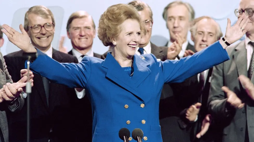 Political fashion: woman leader in blue suit raising arms