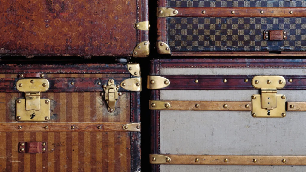 Vintage Louis Vuitton trunks with brass hardware close-up